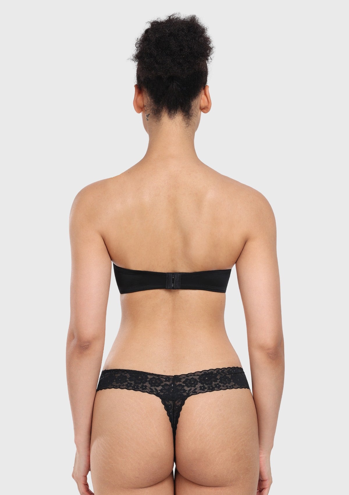 Back view of the black seamless strapless bra, demonstrating the smooth, highly breathable mesh wings that anchor firmly to the body.