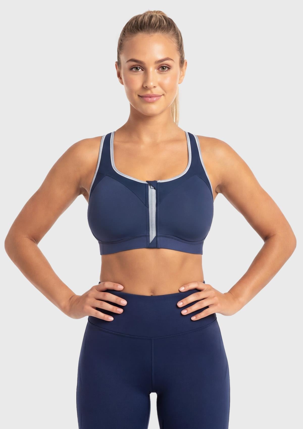 Front view of model wearing the Dark Blue HSIA Speed Race plus size front zip sports bra, featuring a secure auto-lock zipper for high-impact workouts.