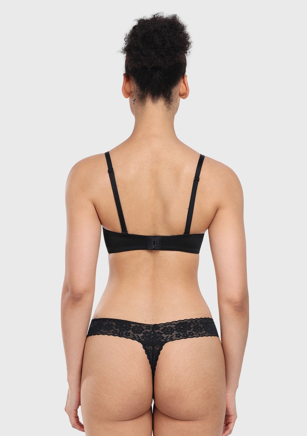 Rear view of the black multiway strapless bra with fabric straps attached, ensuring reliable back support and a versatile fit.