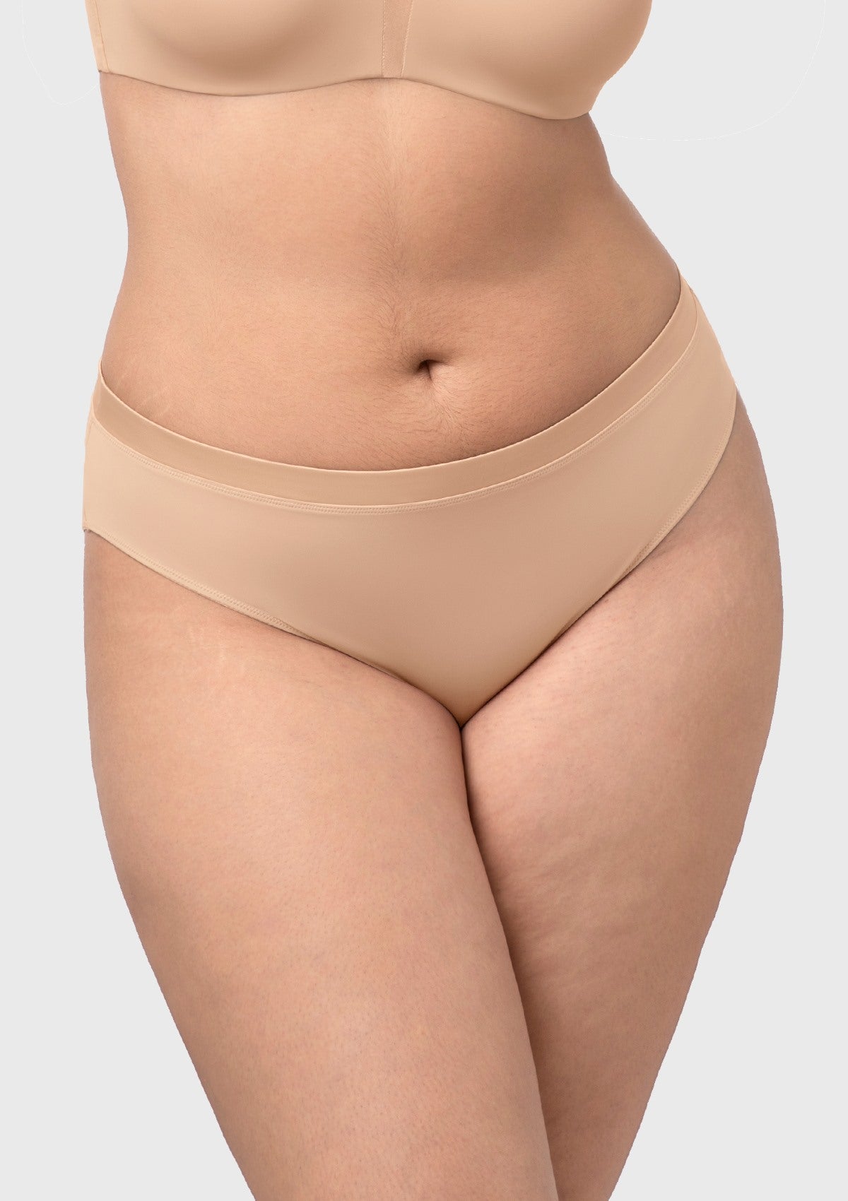 Almond Beige Fiery high-rise cotton bikini underwear on model, front view, crafted from smooth soft fabric.