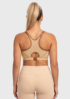 Rear view of the Warm Beige high impact sports bra on model, showing the adjustable underband tension that perfectly respects full-figured curves.