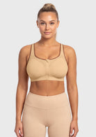  Front view of model wearing the Warm Beige HSIA front closure sports bra, delivering heavy-duty lockdown support and effortless on-and-off convenience.