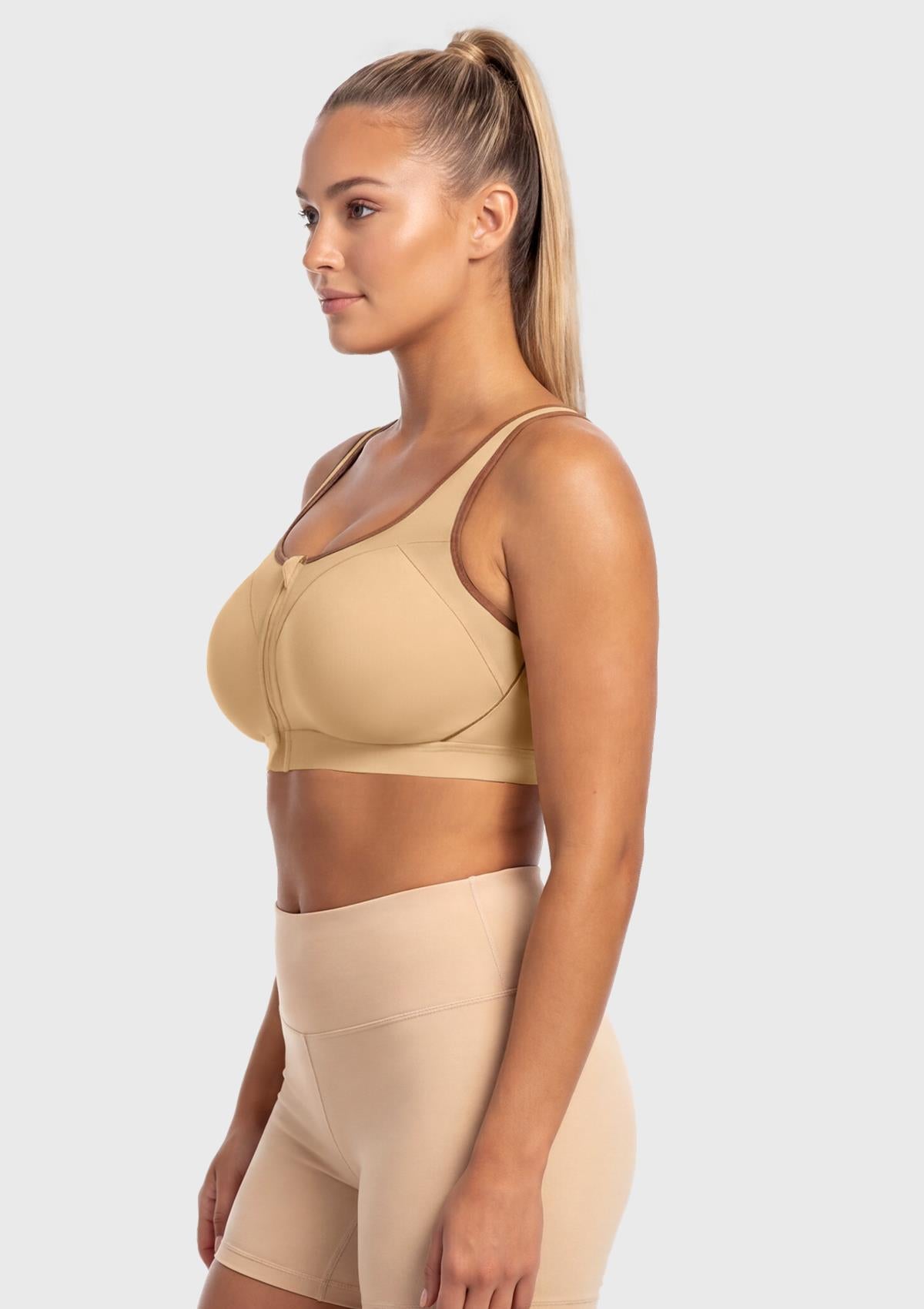 Side profile of the Warm Beige plus size front zip sports bra, emphasizing the anti-chafing inner flap and secure fixed molded cups.