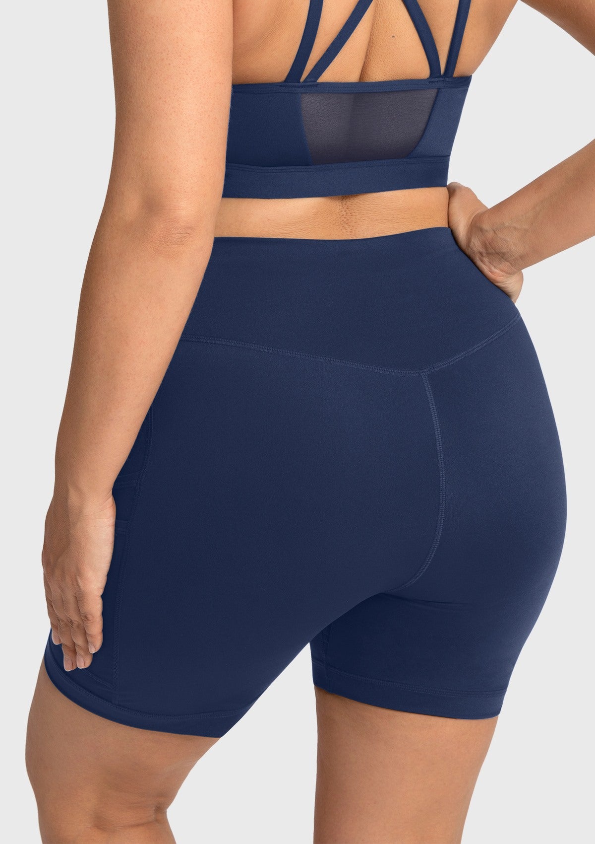 Rear view of the navy blue high-rise gym shorts, delivering a beautifully sculpted silhouette with zero drop-crotch interruptions.