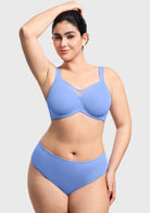Woman with arms raised wearing the sky blue minimizer bra, ensuring no constant readjusting thanks to the secure, wide underband.