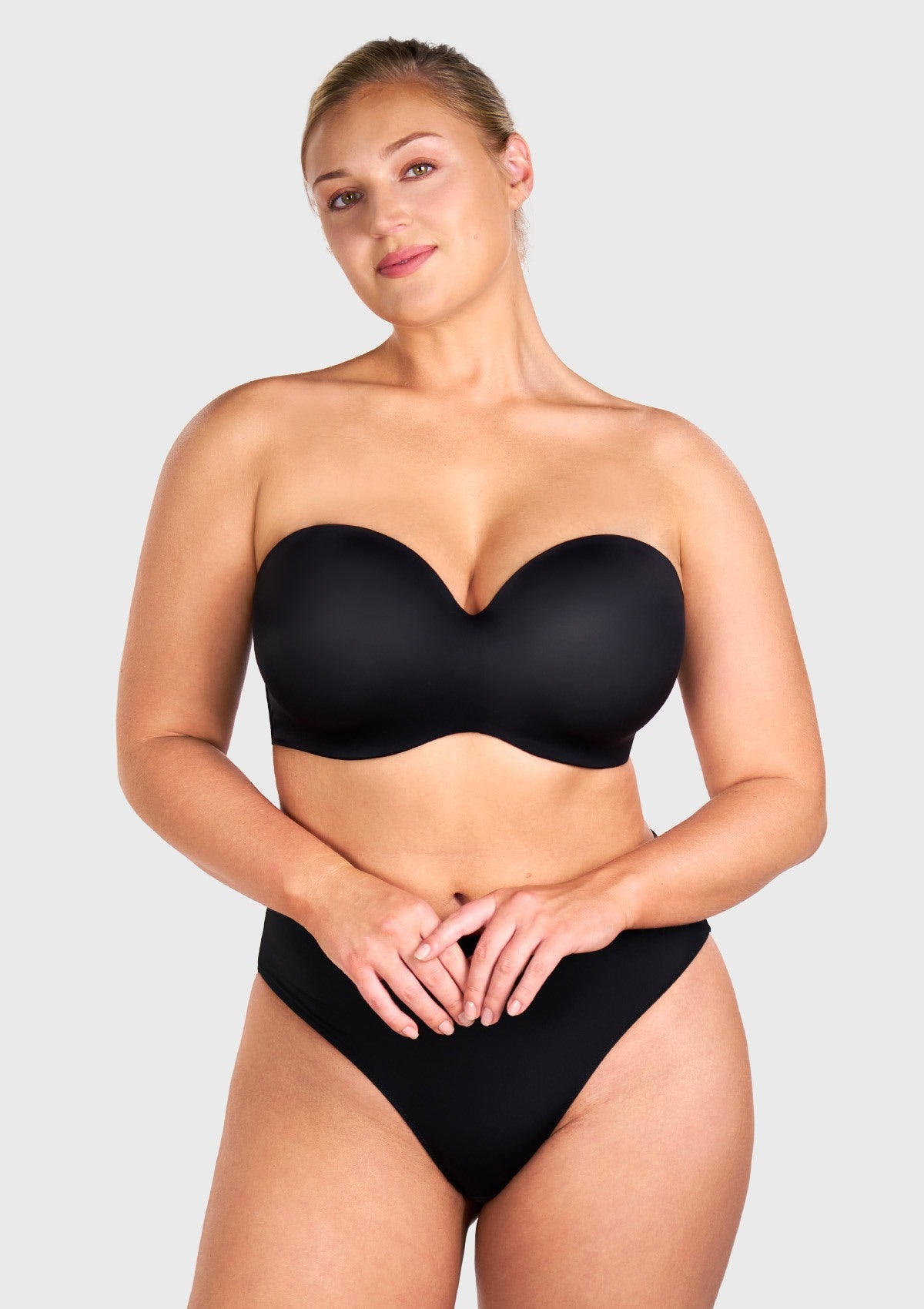 Front view of the black strapless bra worn with convertible straps for daily support
